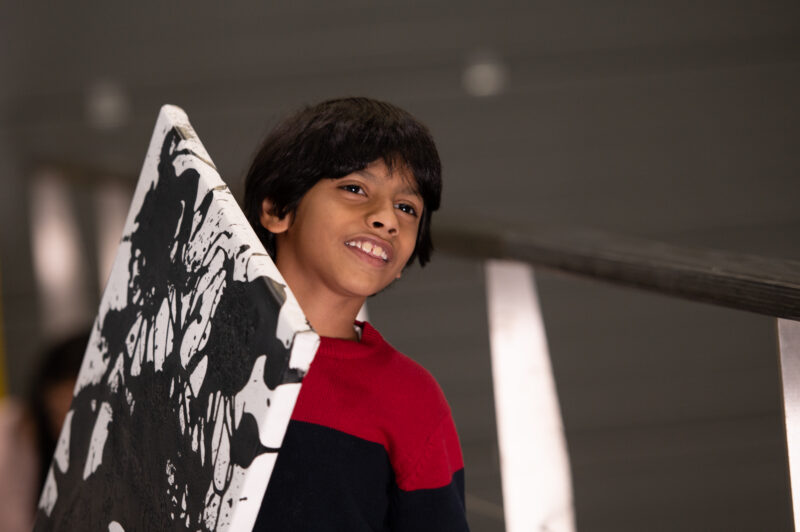 Advait Kolarkar carries his 'Zebra Utopia' artwork on a canvas